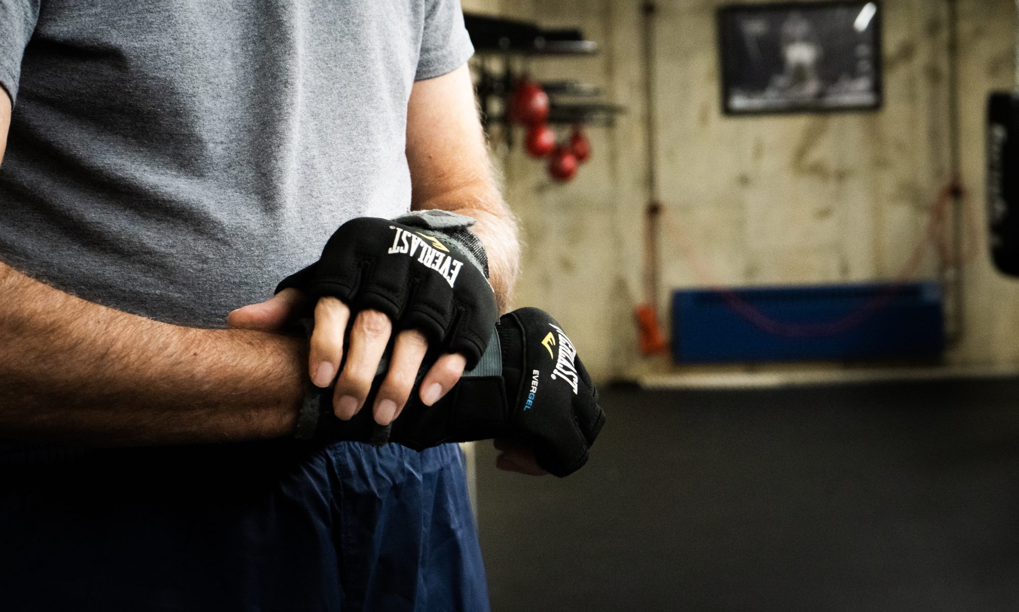 Lutheran Life Villages resident wearing boxing gear with workout equipment in the background