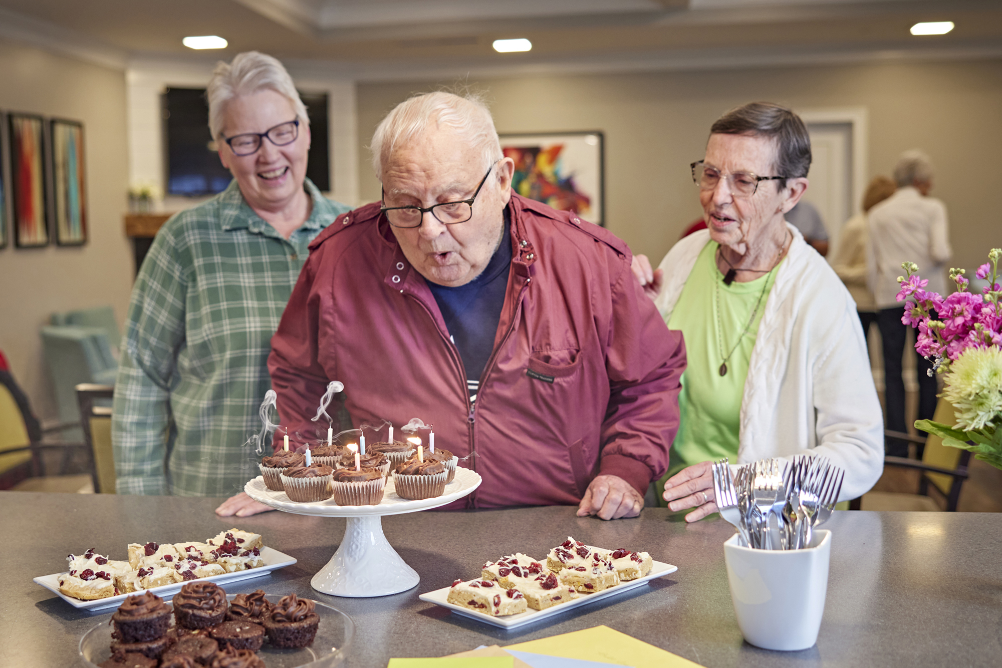 many residents enjoying a birthday celebration